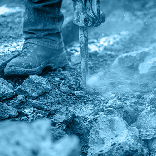 Close up of person wearing boot using power tool